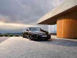 Ein schwarzer S e-tron GT parkt neben einem Haus