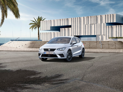 Ein weißer SEAT Ibiza steht vor einem Gebäude